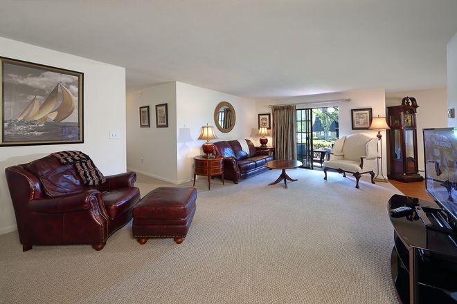 A living room filled with furniture and a clock
