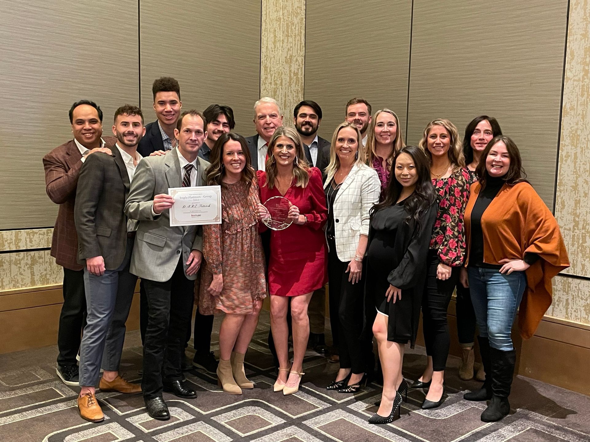 A group of people are posing for a picture in a room.