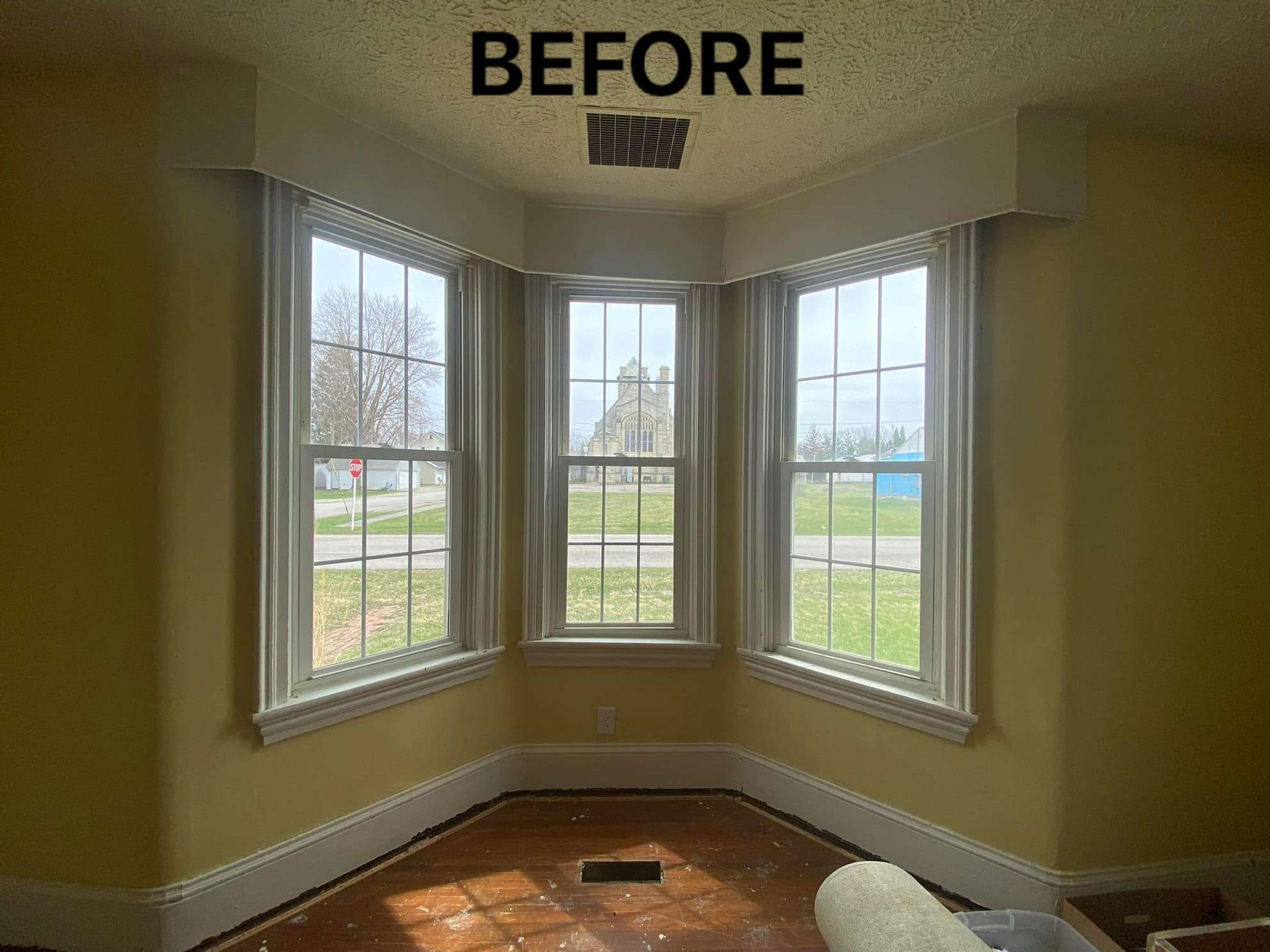 A room with a lot of windows and a sign that says before