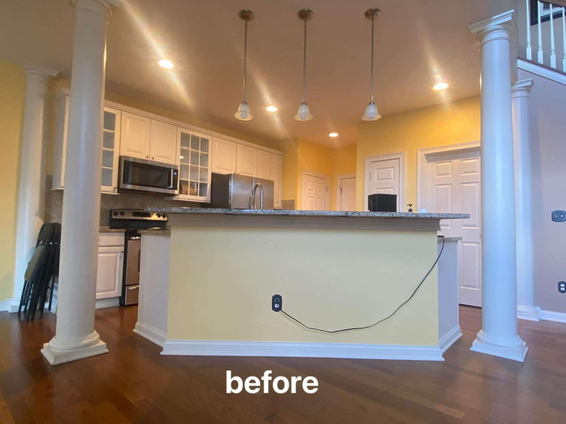 An empty living room with hardwood floors and a fireplace.
