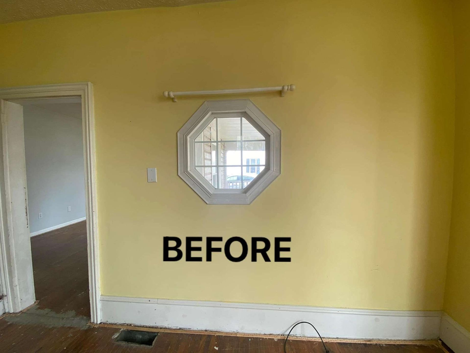 A room with a window and the word after on the wall.
