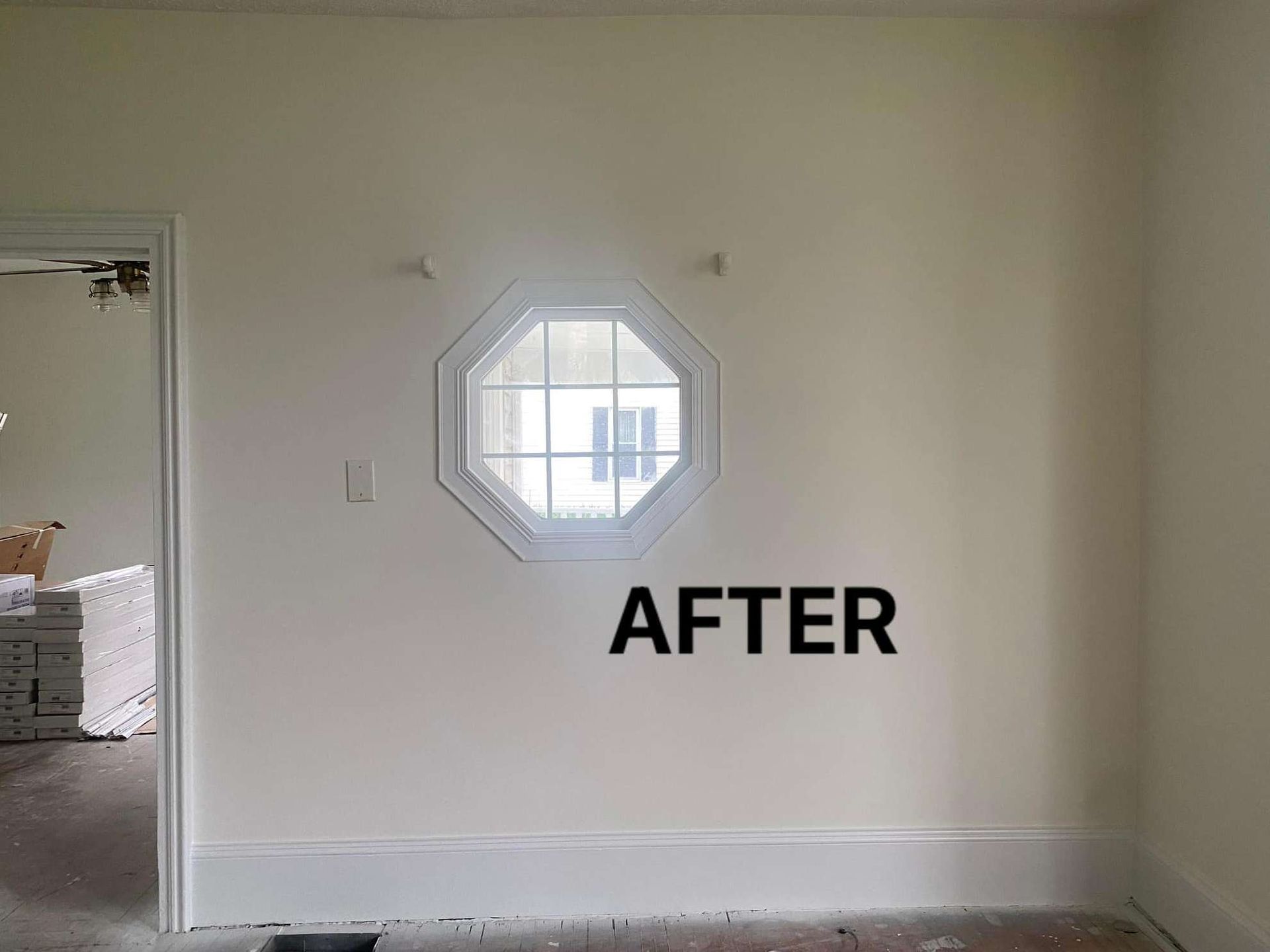 A room with a window and the word after on the wall.