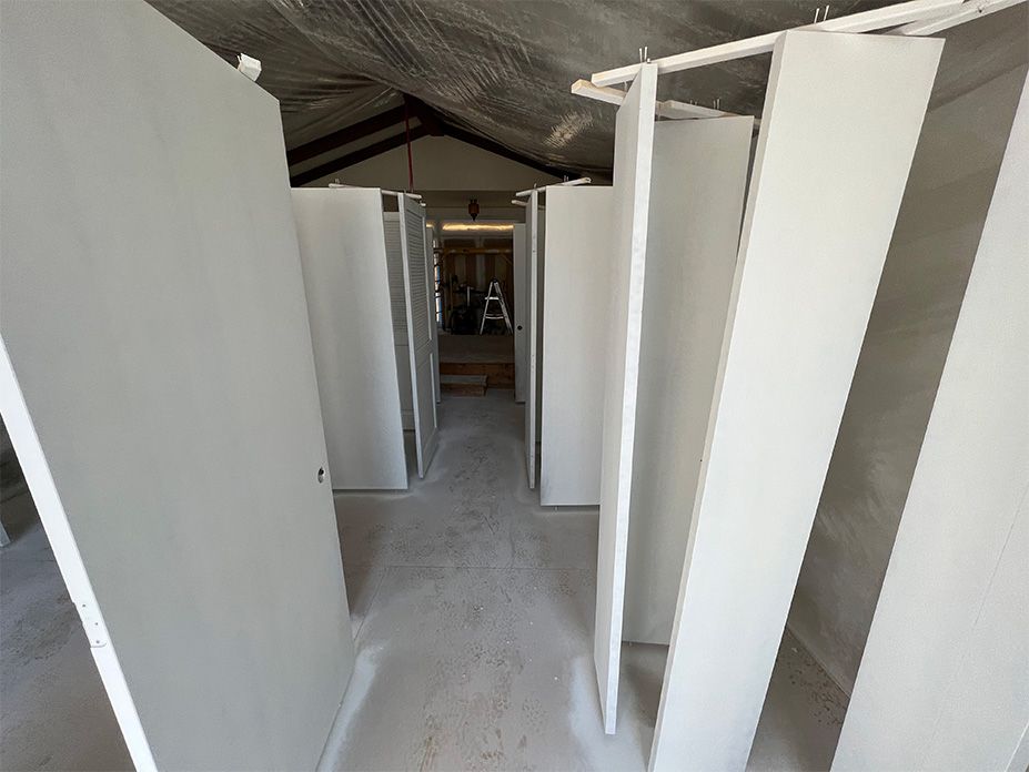 A room with a lot of white walls and a ladder