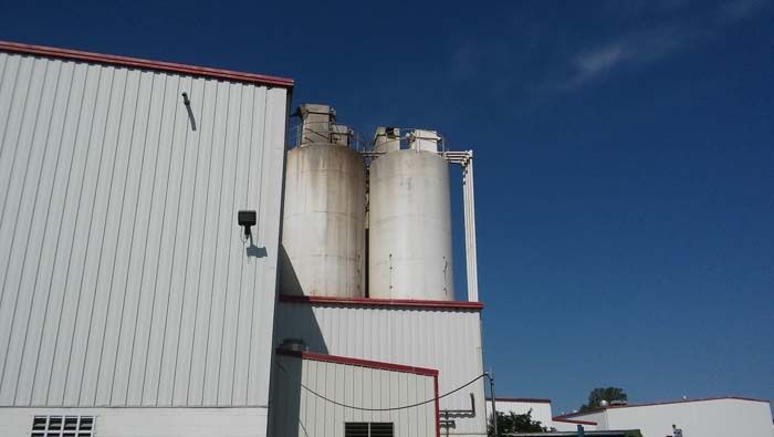 A large white building with a blue sky in the background