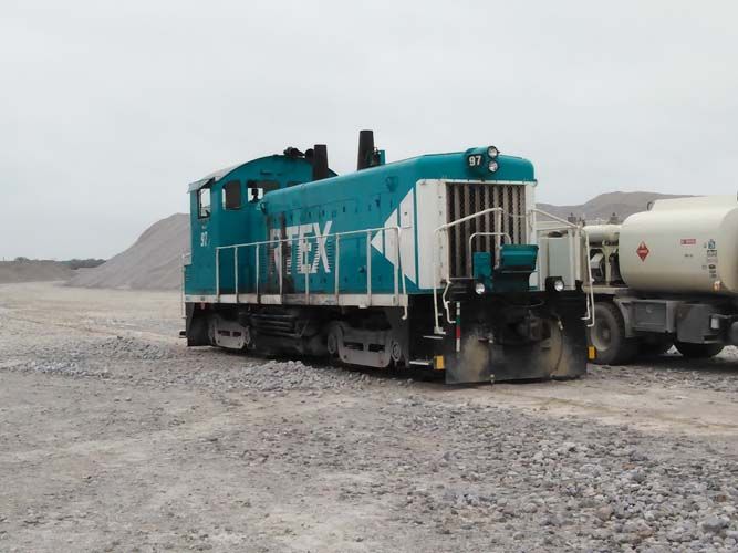 A blue and white train with the word tex on it