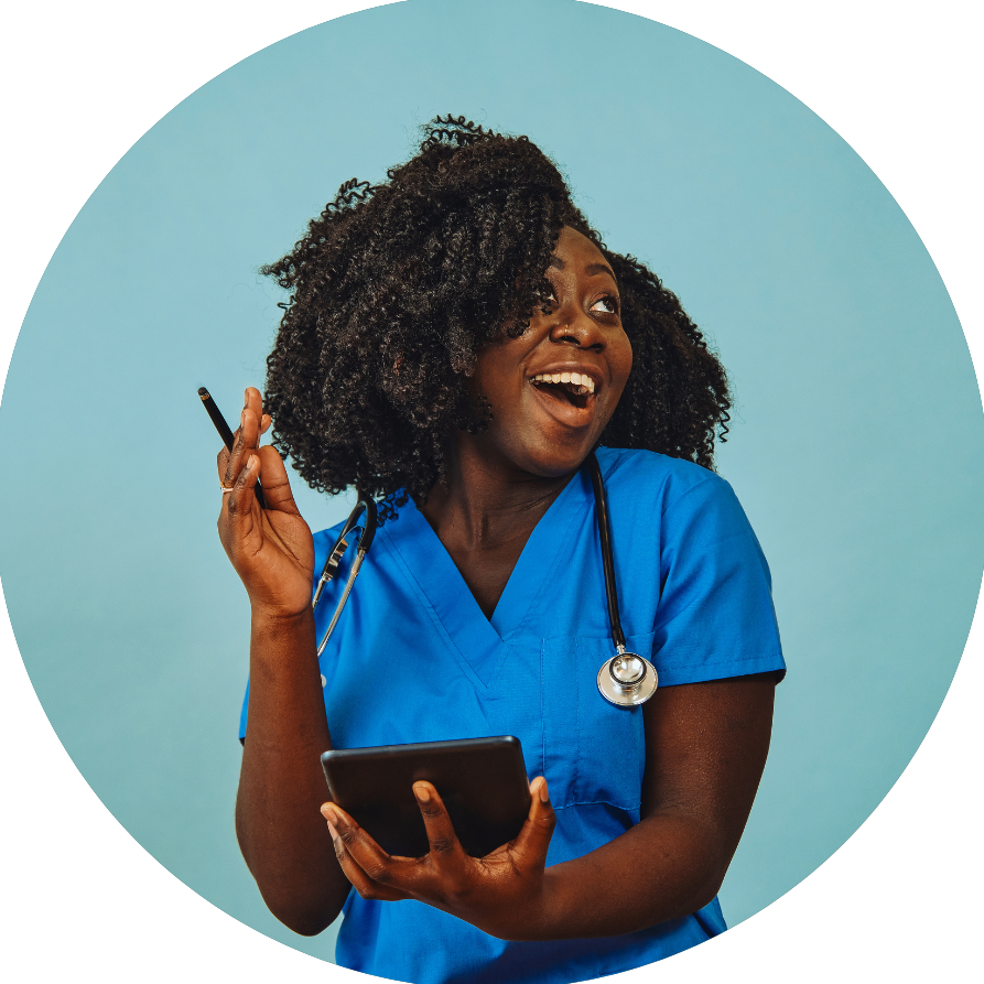 A woman in a blue scrub is holding a tablet and a pen.