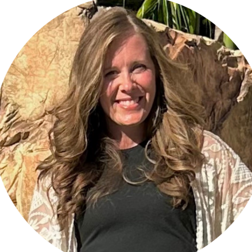 A woman in a black shirt and white cardigan is smiling in a circle.