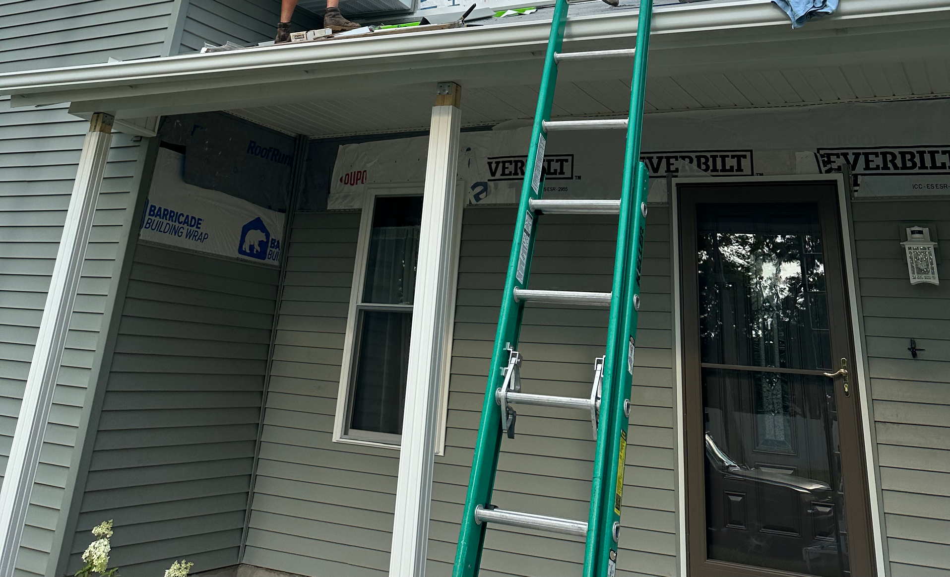 Door Installation — Man Installing Sliding Glass Door in Syracuse, IN Door Installation — Man Installing Sliding Glass Door in Syracuse, IN