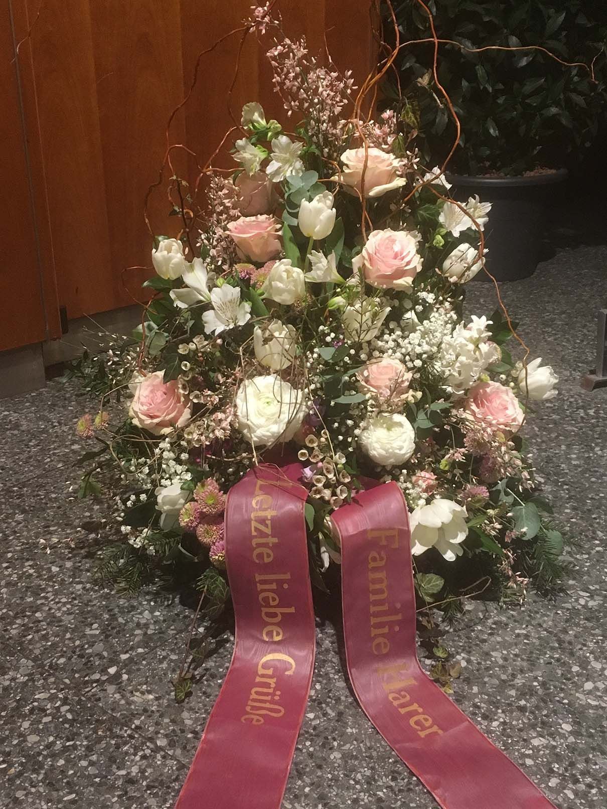 Ein Blumenstrauß mit einer roten Schleife mit der Aufschrift „Familie“