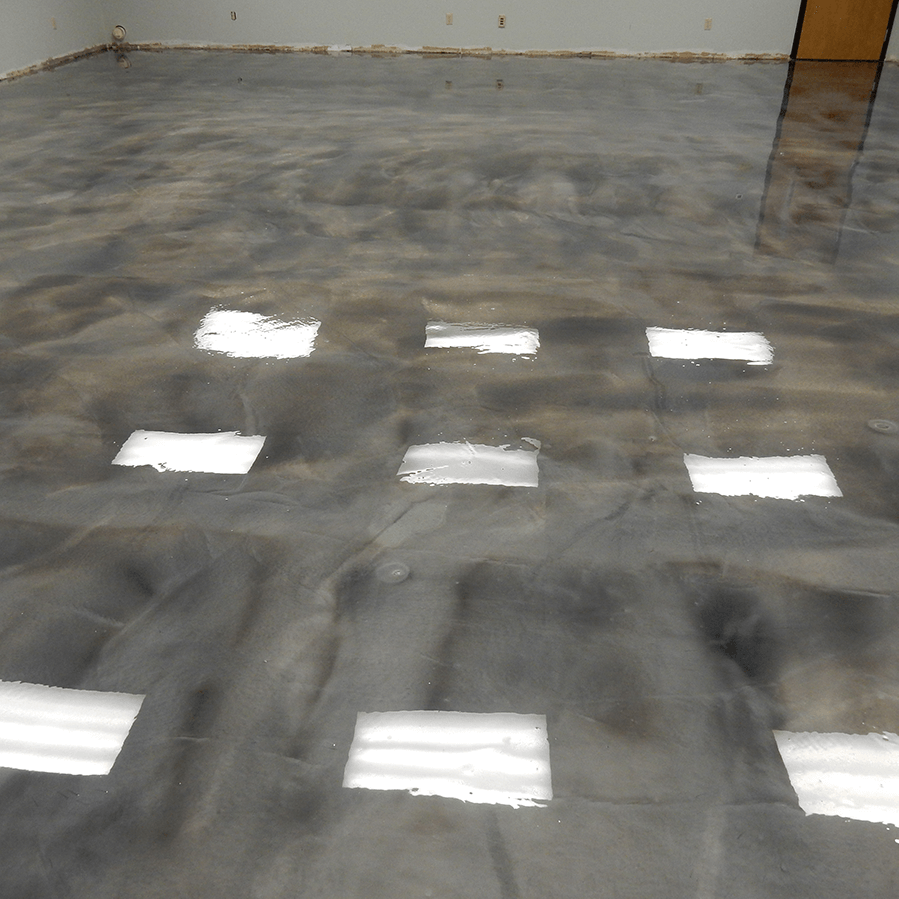 A shiny gray concrete floor with a lot of squares reflected on it
