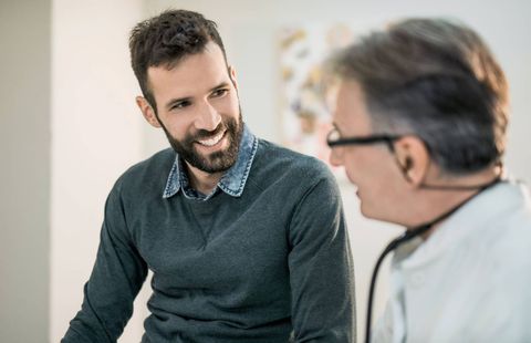 Happy Mid Adult Male Patient Talking With His Doctor — Greensburg, IN — DC Integrated Medicine Happy Mid Adult Male Patient Talking With His Doctor — Greensburg, IN — DC Integrated Medicine