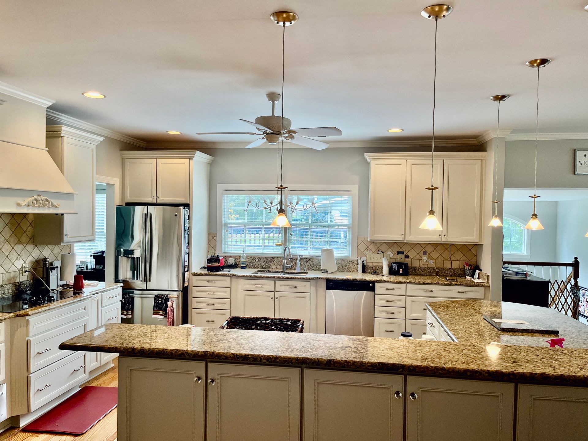 A kitchen with white cabinets and granite counter tops