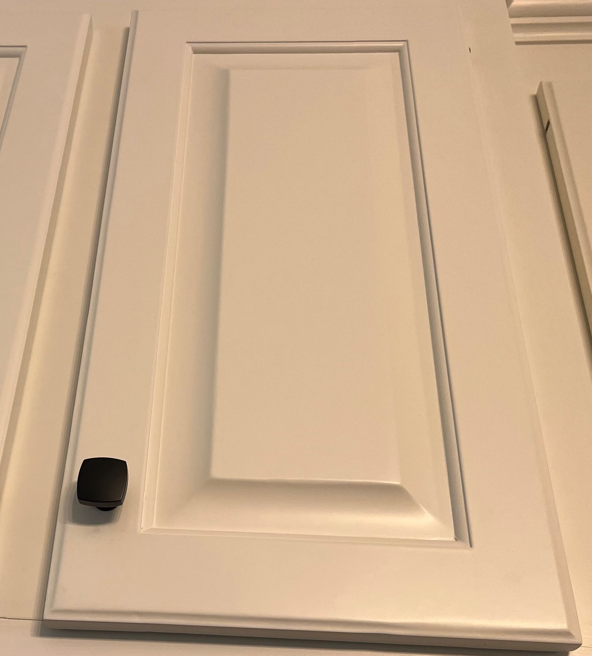 A white door with a black knob on it