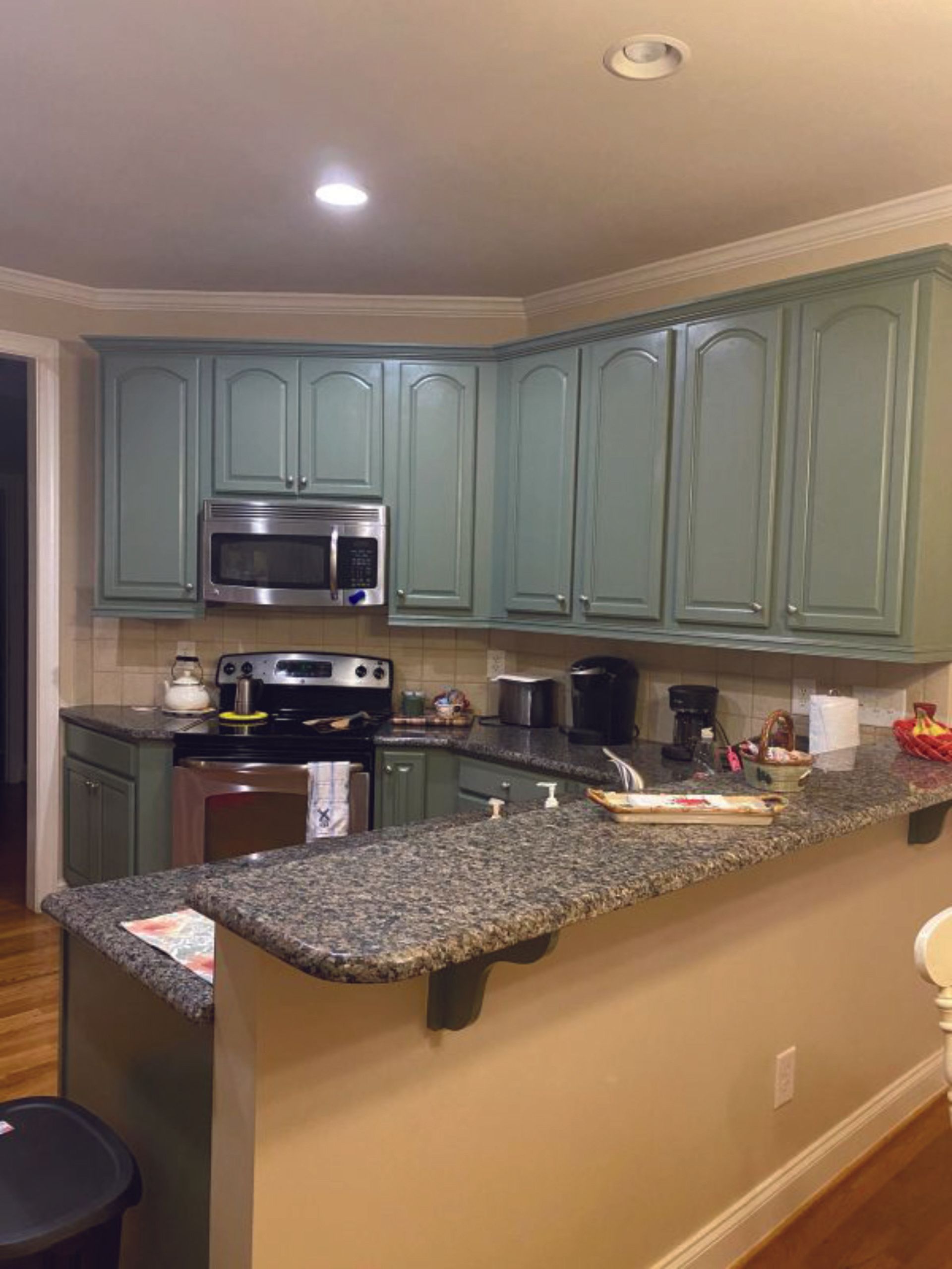 A kitchen with blue cabinets and granite counter tops.