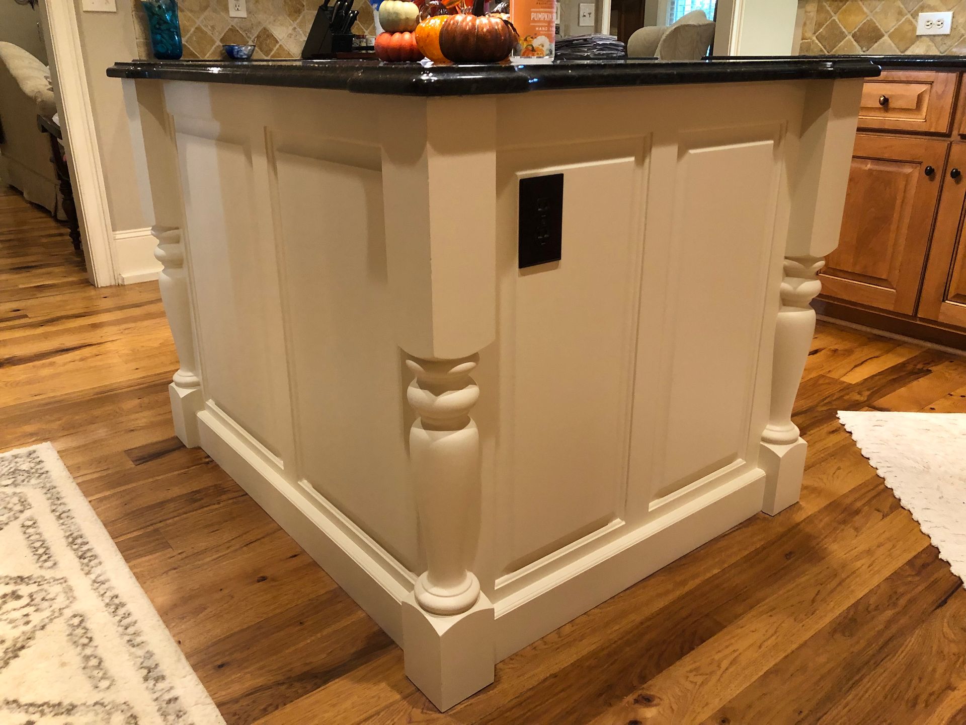 A kitchen island with pumpkins on top of it
