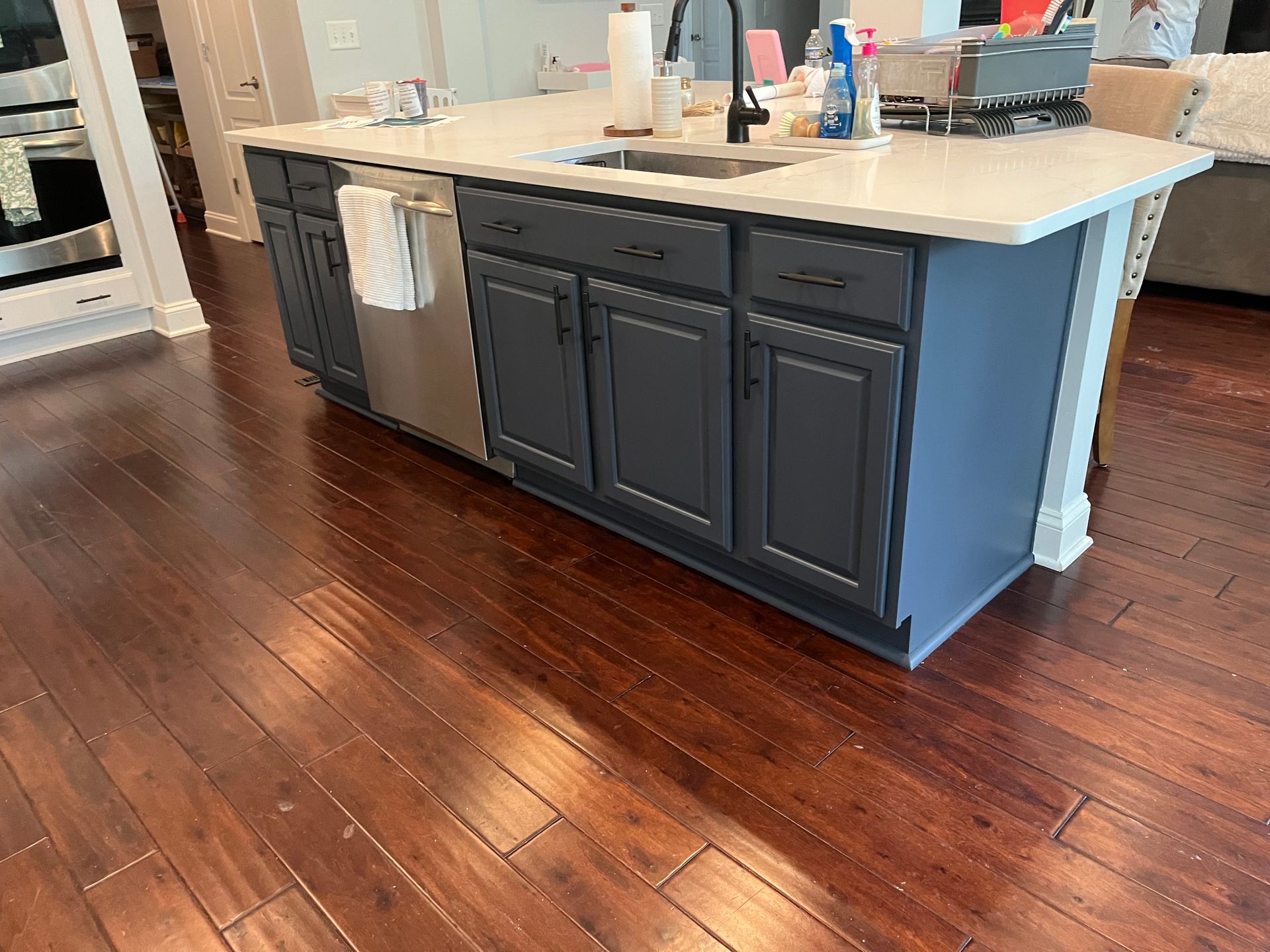 A kitchen with a large island and a sink.