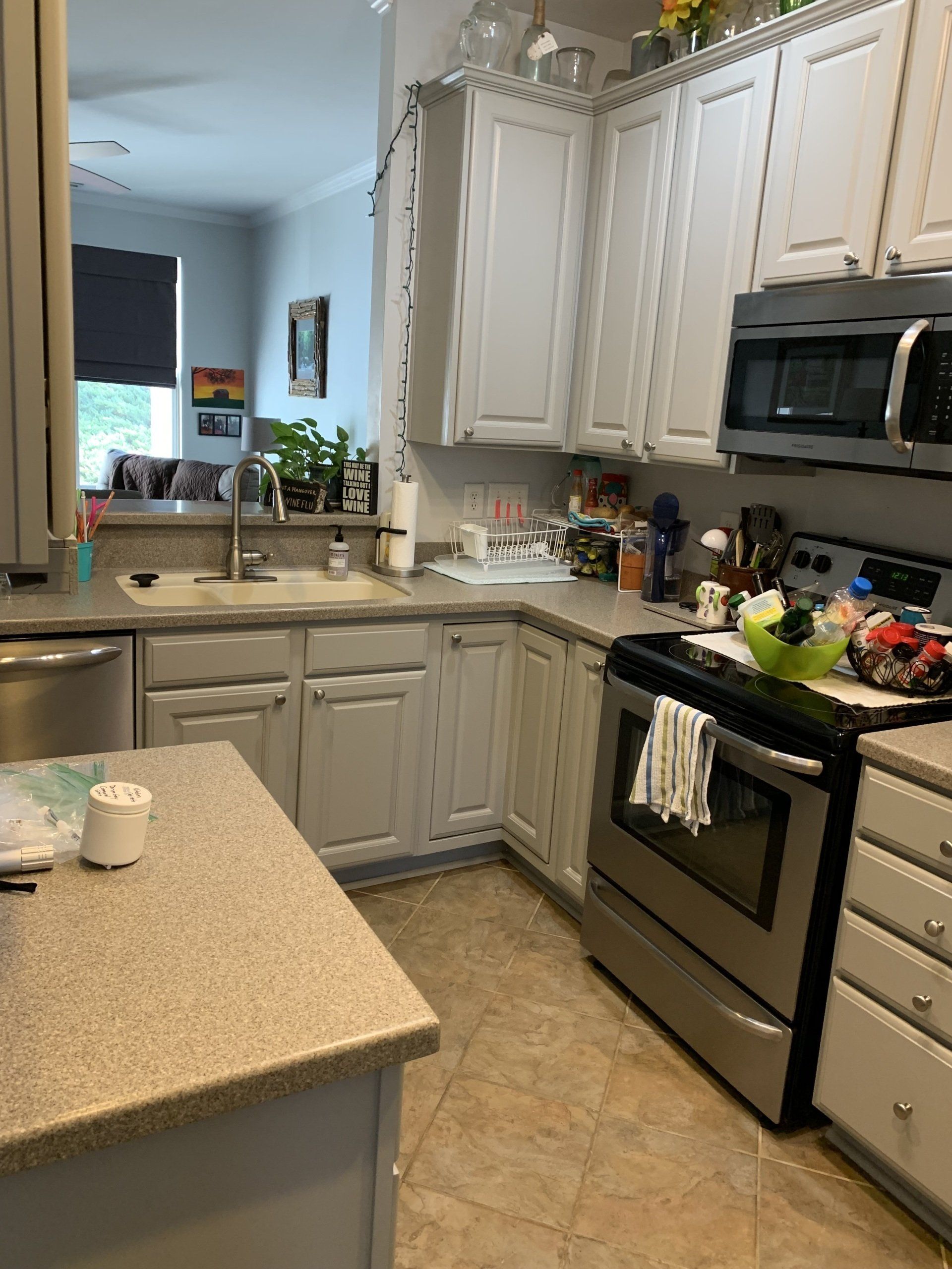 A kitchen with white cabinets and stainless steel appliances.
