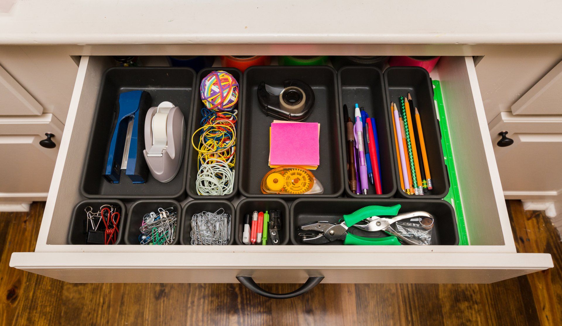A drawer filled with a variety of office supplies.