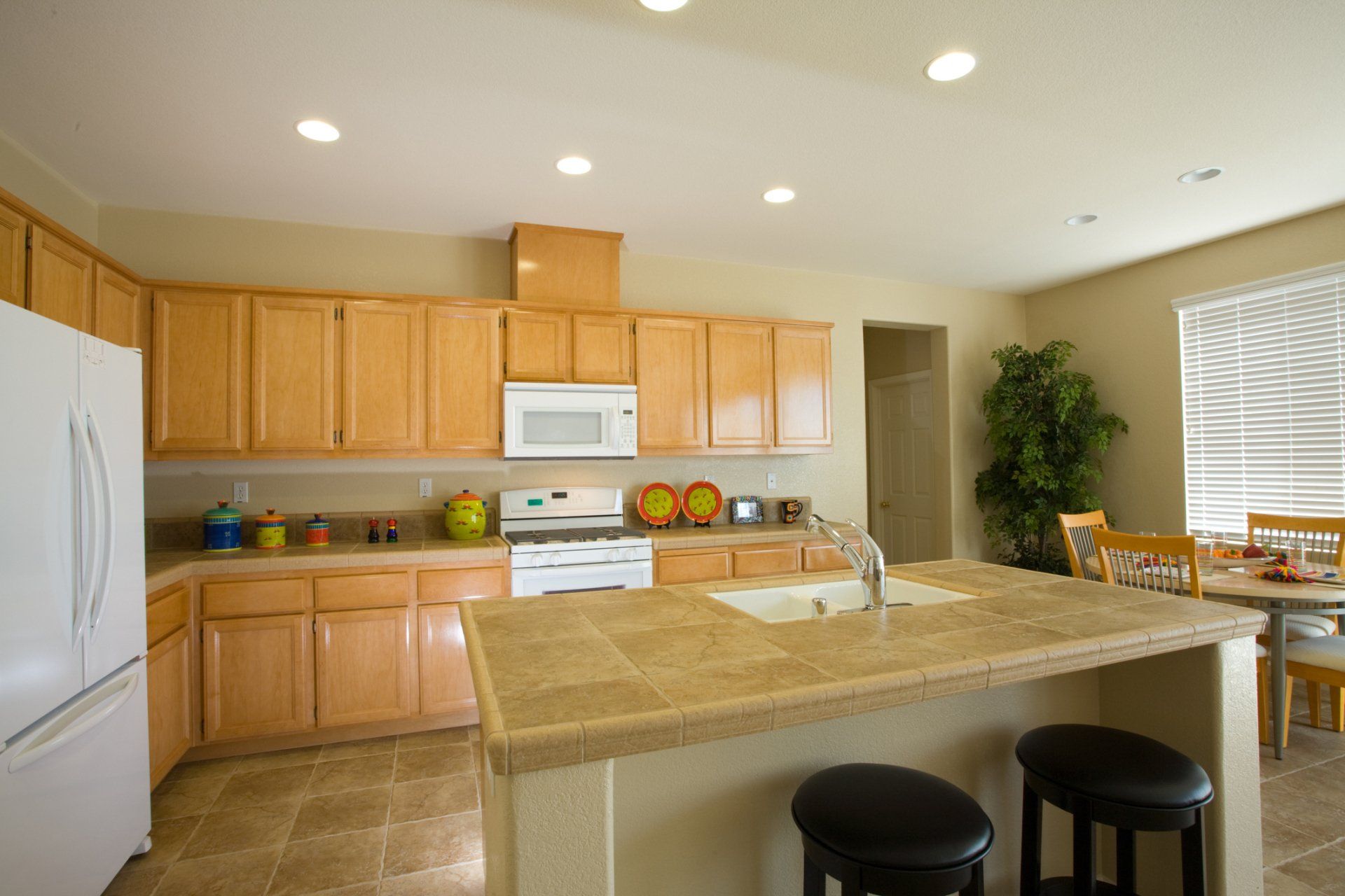 A kitchen with wooden cabinets and granite counter tops