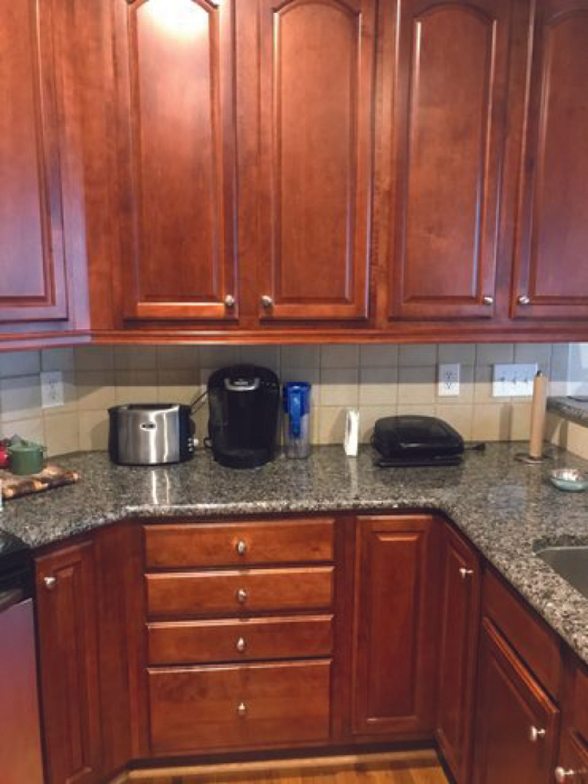 A kitchen with wooden cabinets and granite counter tops