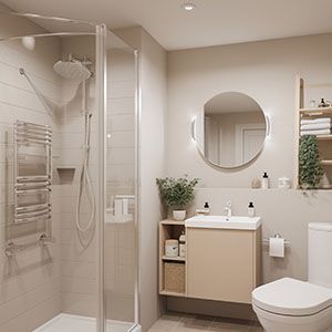 Modern beige bathroom with glass shower, round mirror, vanity, and white toilet