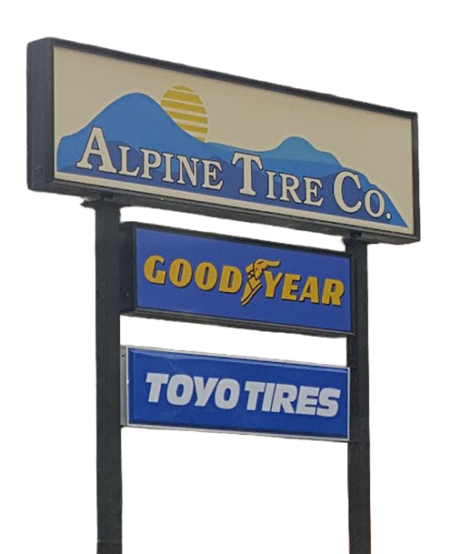 A sign for Alpine Tire Co. with smaller signs underneath for Goodyear and Toyo Tires against a white background. | Avon Auto & Truck
