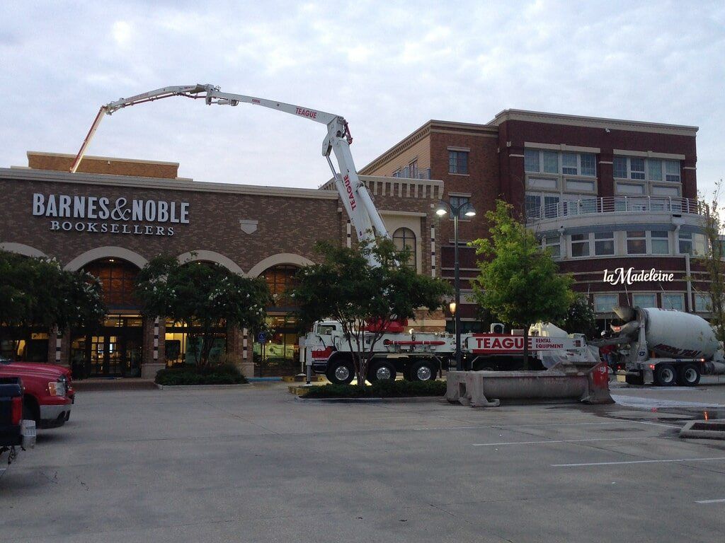 Crane Truck Near Commercial Building — Baton Rouge, LA — Teague Rental Equipment LLC