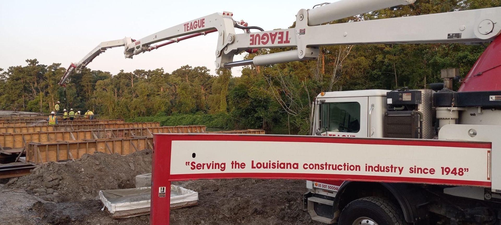 Concrete pump truck at a construction site in Louisiana, with text: 