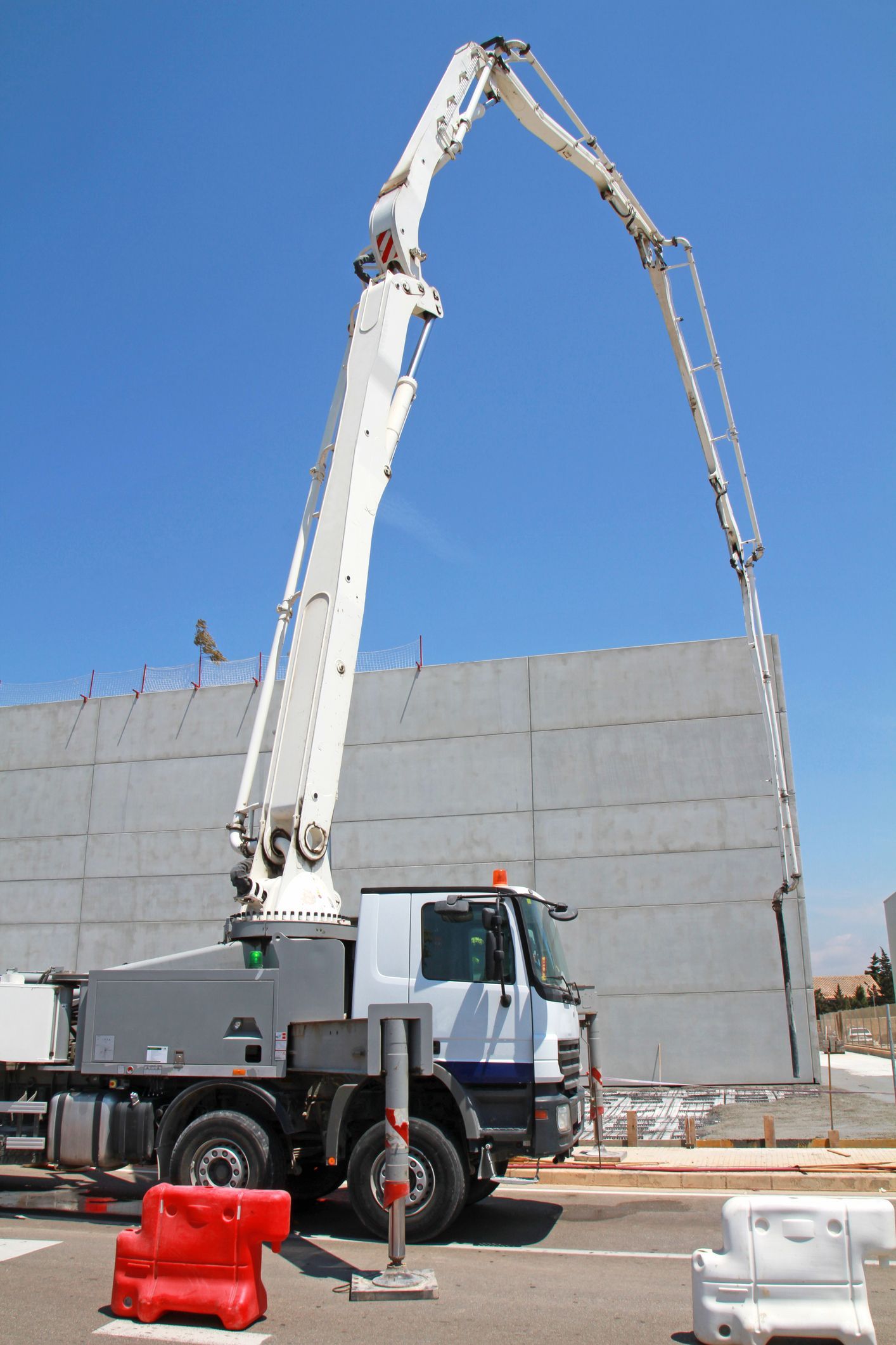 Modern pumping truck from Teague Rental Equipment providing concrete pumping services for a construction project in Slidell, LA.