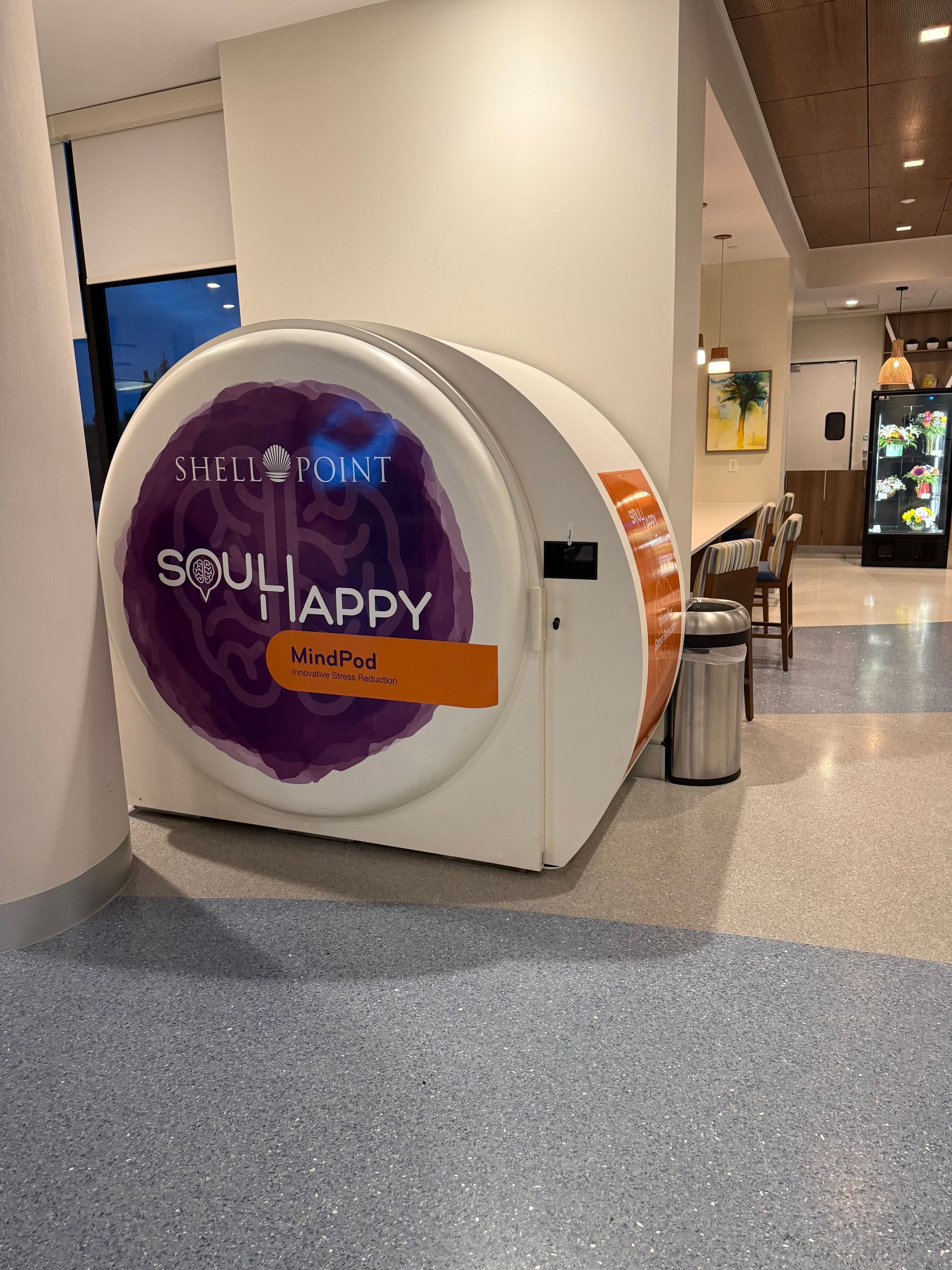 Circular sign with purple “Soul Happy” graphic in a mall hallway