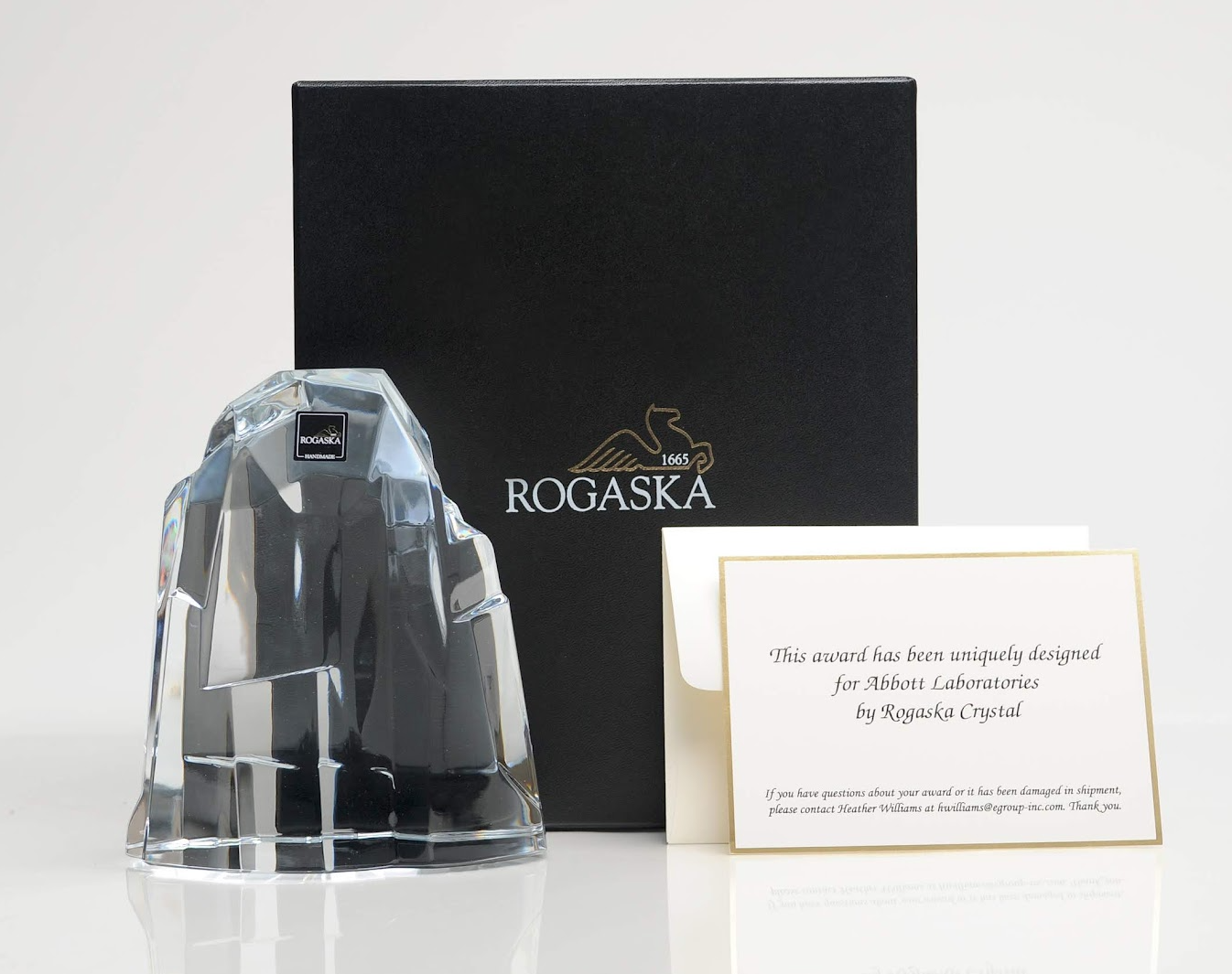 Crystal sculpture, box, and card; sculpture resembles a mountain.