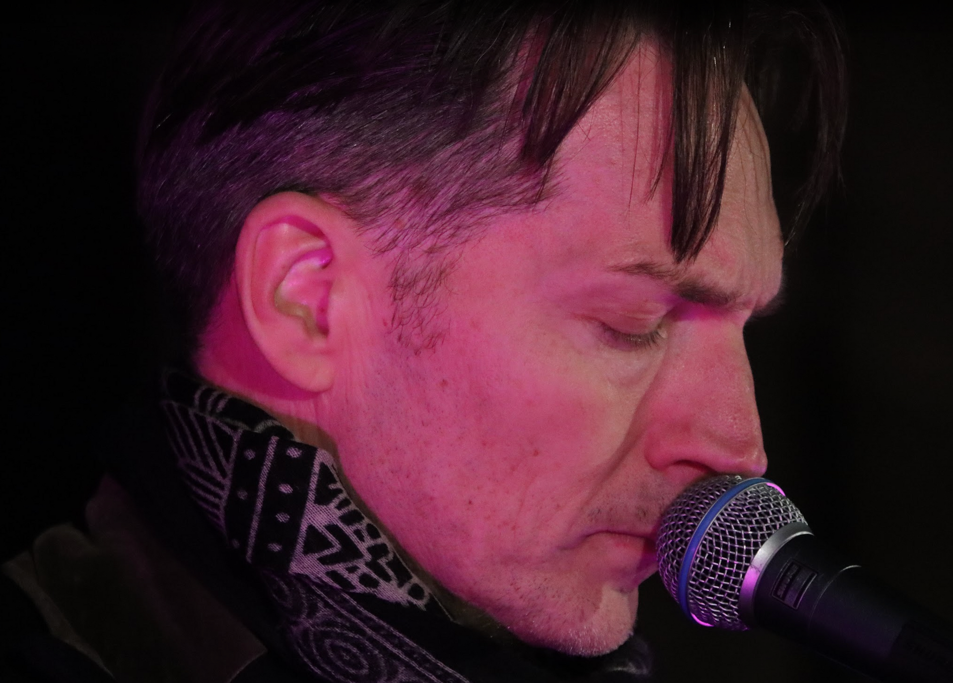 Man with short dark hair and goatee, wearing black shirt, looking at camera.