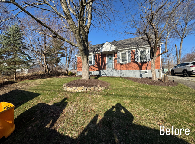 A before picture of a house with a playground in front of it.