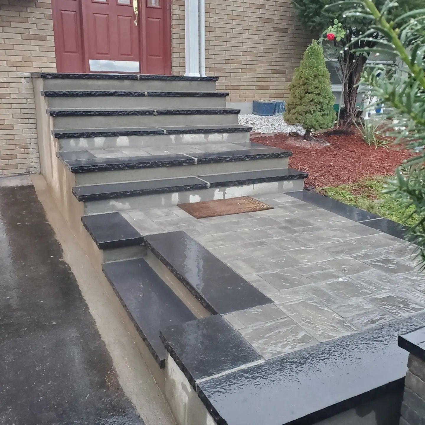 A set of stairs leading up to the front door of a house