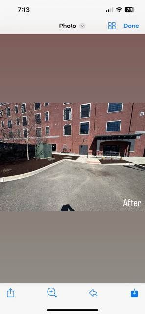 A phone screen shows a picture of a building and a street.