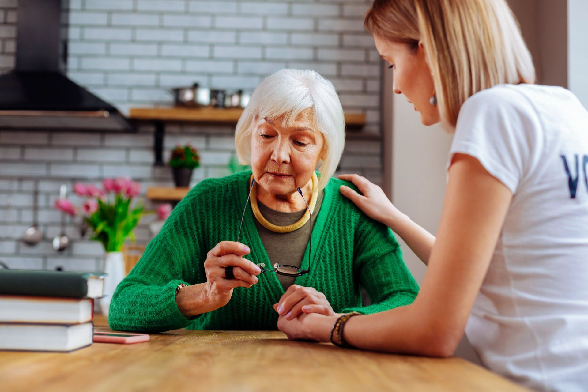 Elderly woman distraught while younger woman comforts her