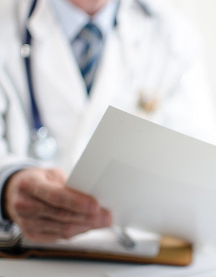 Close up of doctor holding medical paperwork