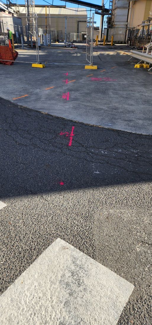 View of Industrial Site With Pink Markings on the Asphalt and Gravel — Found It Down Under in Glenwood, QLD