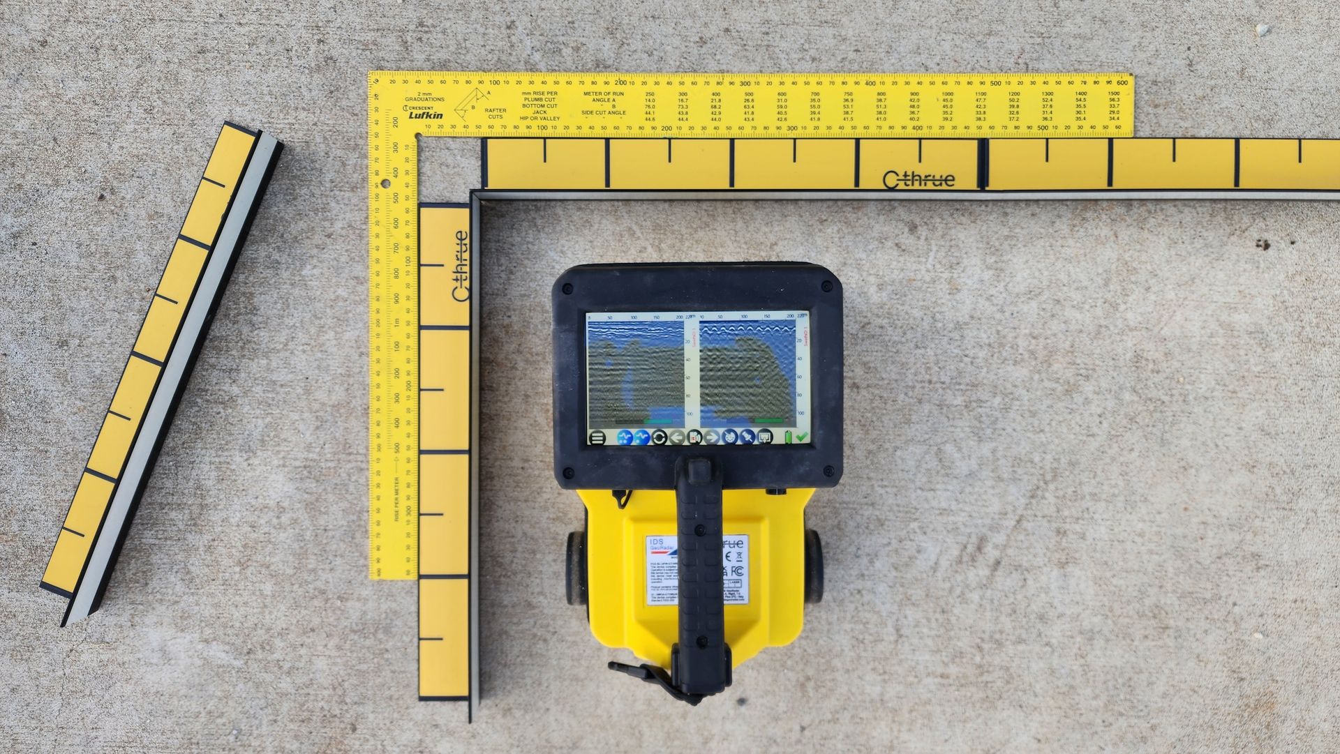 Yellow Surveying Equipment With a Screen, Measuring Tools, and a Concrete Surface — Found It Down Under in Glenwood, QLD