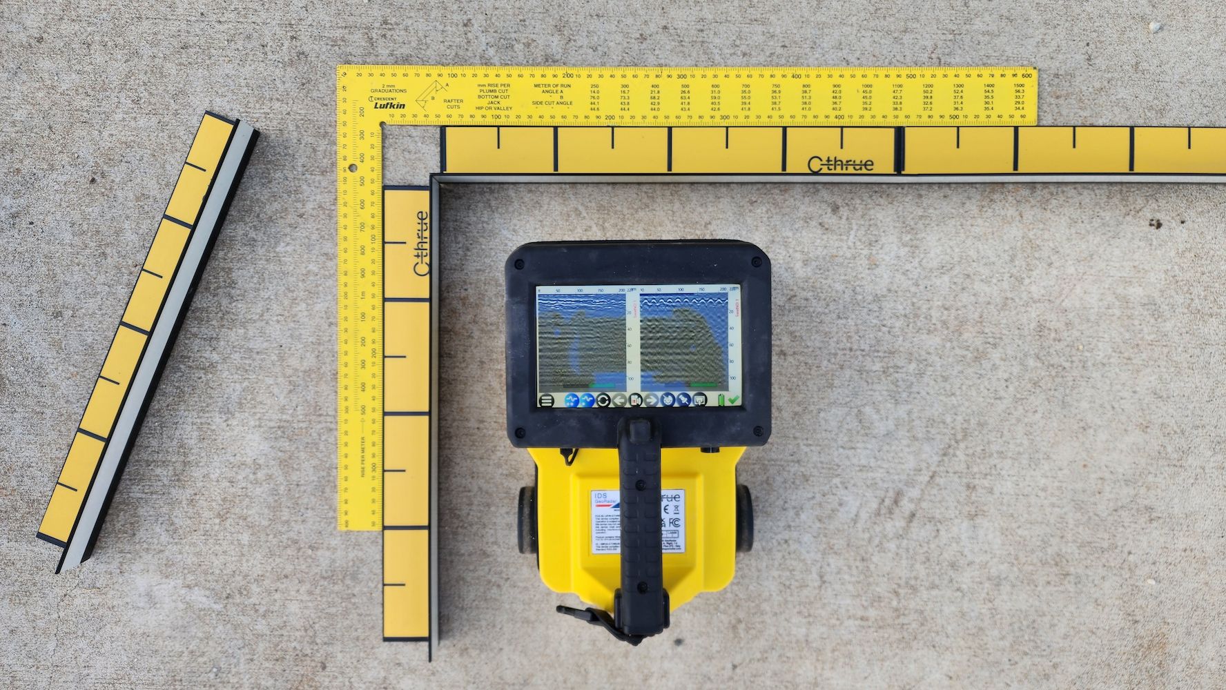 Yellow Surveying Equipment With a Screen, Measuring Tools, and a Concrete Surface — Found It Down Under in Gunalda, QLD