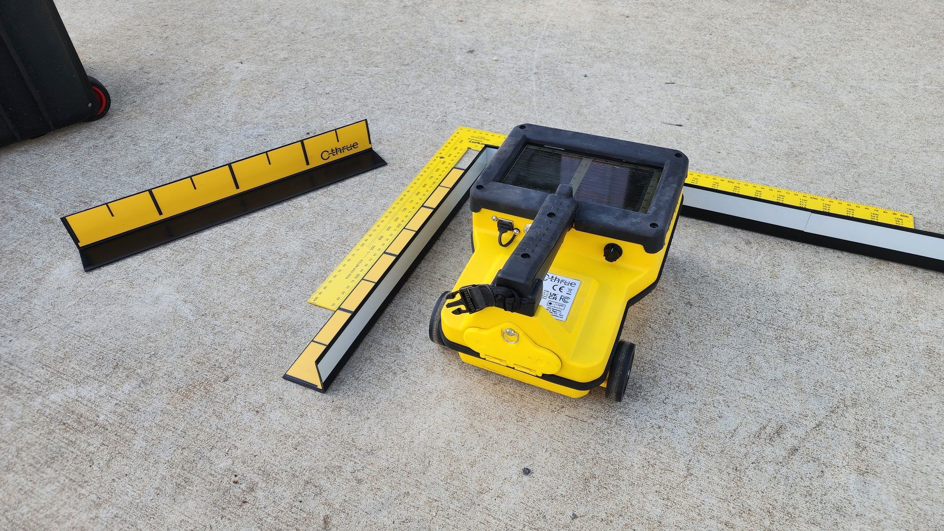 Yellow Surveying Device With Rulers on Concrete Surface — Found It Down Under in Rainbow Beach, QLD