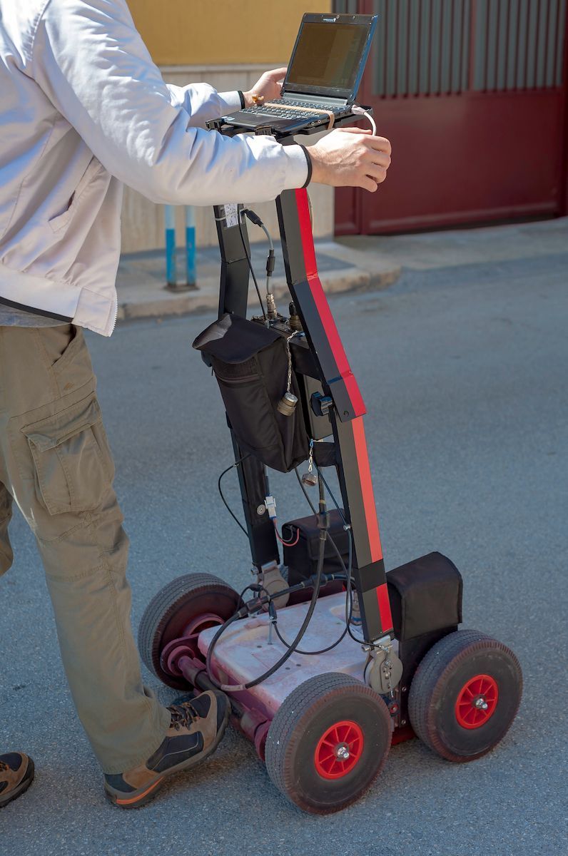 Person Using a Ground-penetrating Radar Cart Outdoors — Found It Down Under in Glenwood, QLD