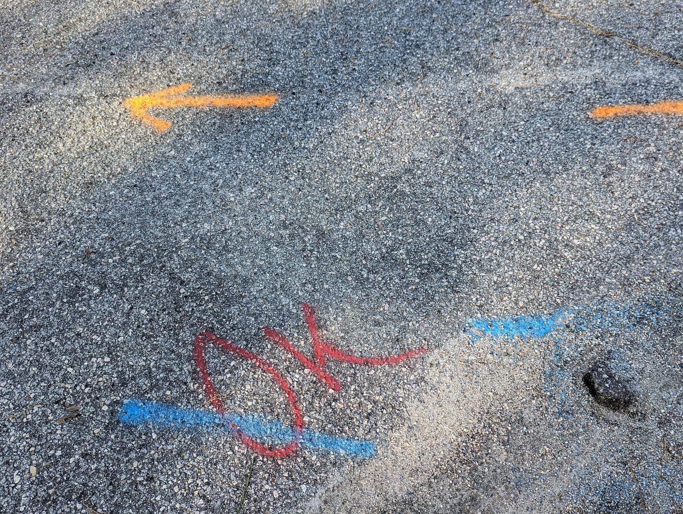 Arrows Painted on a Gray, Pebbled Surface — Found It Down Under in Curra, QLD