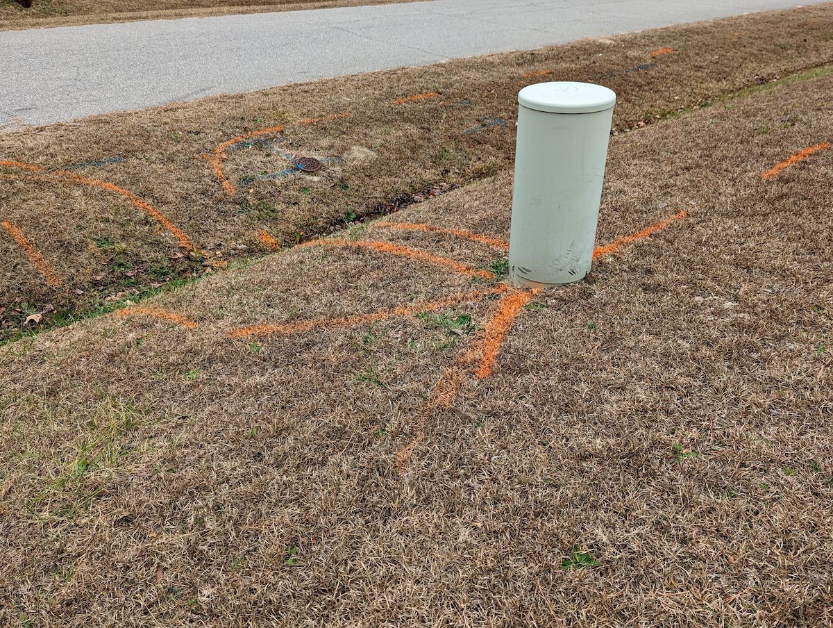 White Utility Pole in Brown Grass With Orange Markings, Near a Road — Found It Down Under in Widgee, QLD
