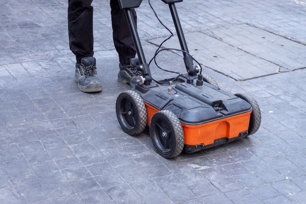 Person Using a Ground-penetrating Radar Machine on Pavement — Found It Down Under in Fraser Coast, QLD