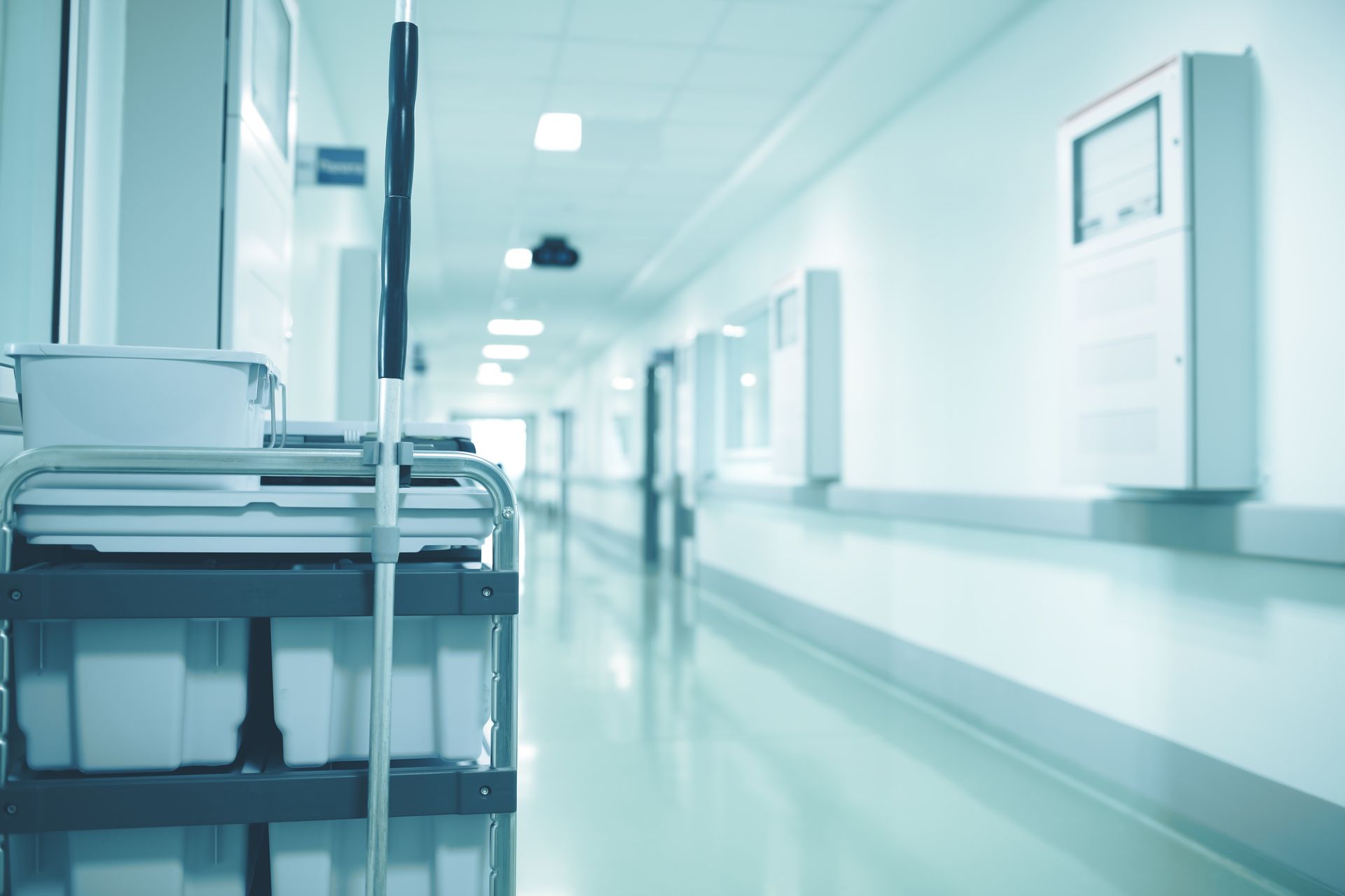 Hospital hallway with cleaning cart in foreground, leading to the light at the end. Hospital hallway with cleaning cart in foreground, leading to the light at the end.