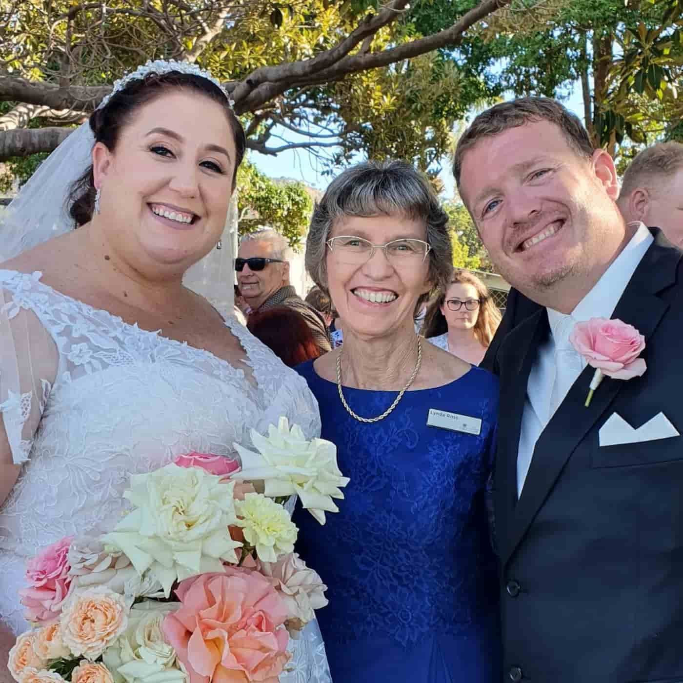 A Bride And Groom Are Posing For A Picture With Their Mother — Lynda Ross Marriage Celebrant In Ingham, QLD