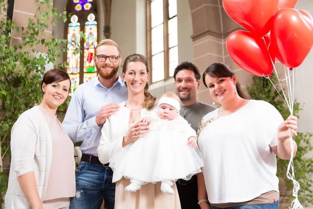A Group Of People Are Posing For A Picture With A Baby In A Church — Lynda Ross Marriage Celebrant In Alice River, QLD