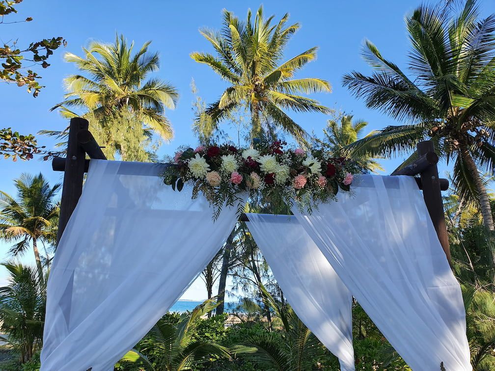 Flowers Decorating A Structure Next to The Beach For A Wedding — Lynda Ross Marriage Celebrant In Mission Beach, QLD
