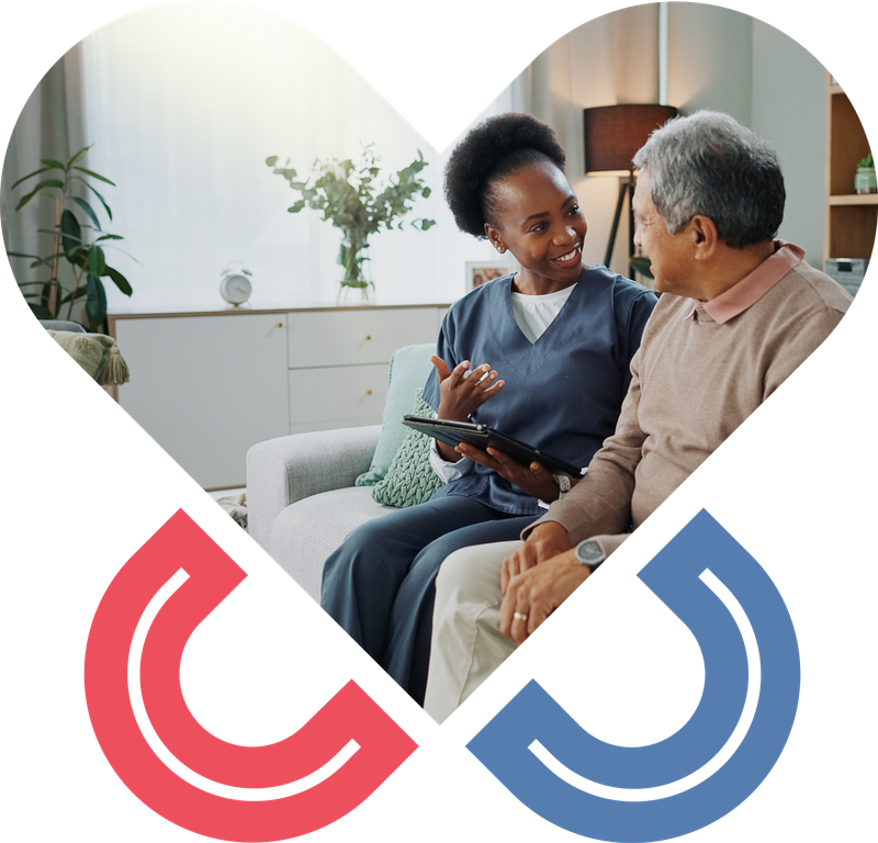 Smiling care taker talking to a smiling senior